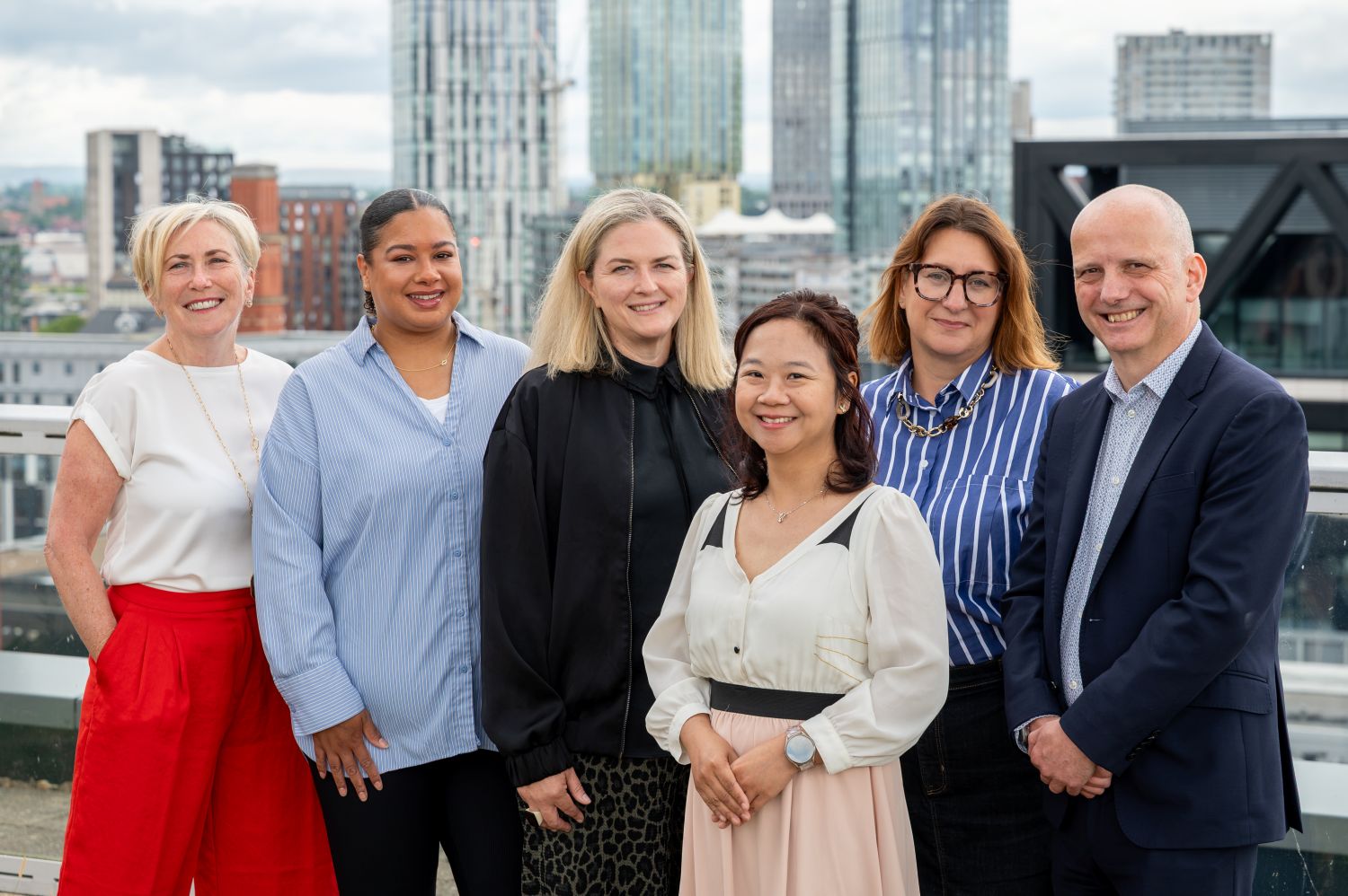 Business and Inward Investment Team stood together with the MediaCity skyline in the background