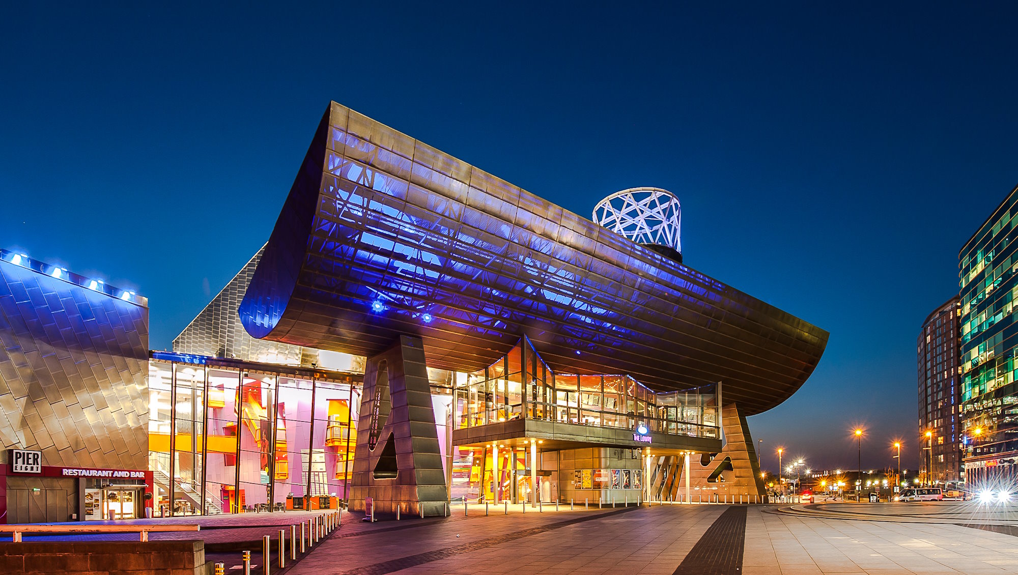 The outside of Lowry, lit up at night