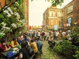 A group of people sat in a beer garden