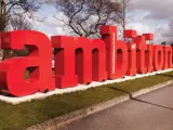Sculpture of the word ambition outside the University of Salford